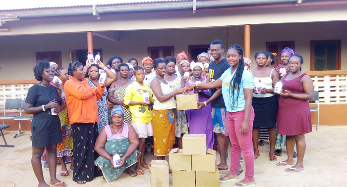 Nii Aryee Tagoe , president of the association, and his vice president, Portia Buernarkie Nartey, presenting boxes of body lotion to some women in the community Nii Aryee Tagoe , president of the association, and his vice president, Portia Buernarkie Nartey, presenting boxes of body lotion to some women in the community
